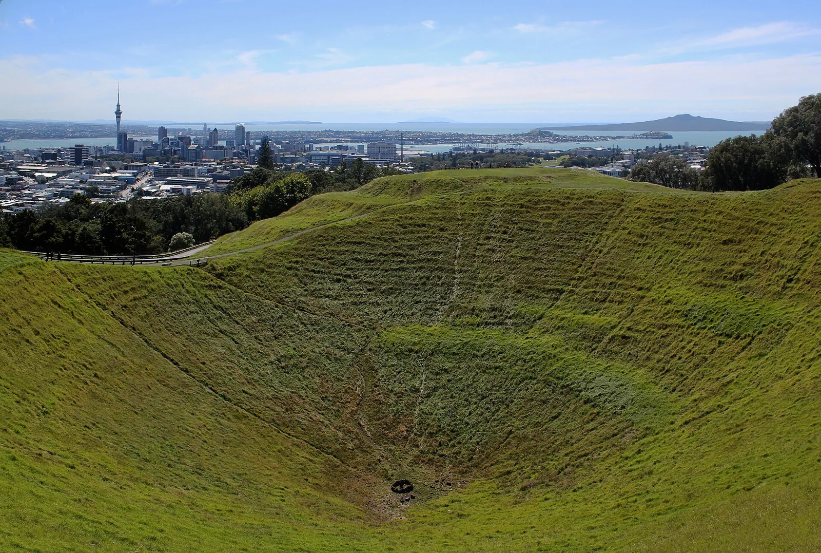 Mount Eden's grassy crater with the Auckland skyline behind