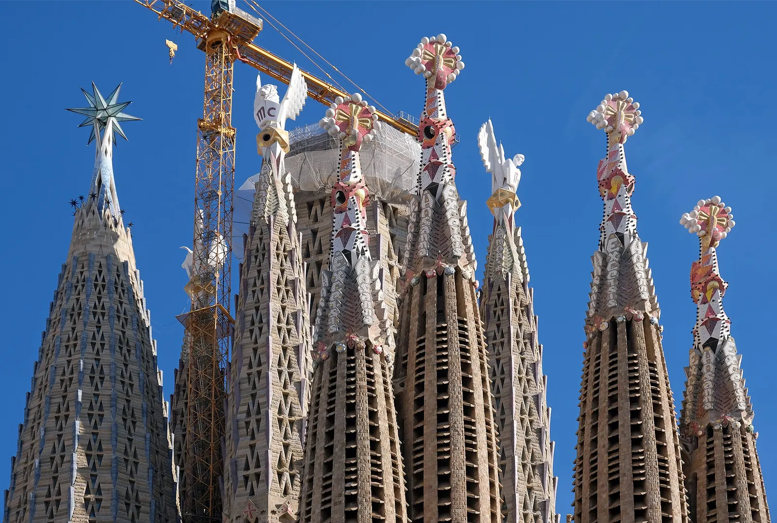 The spires of the Sagrada Família against a deep blue sky in Barcelona