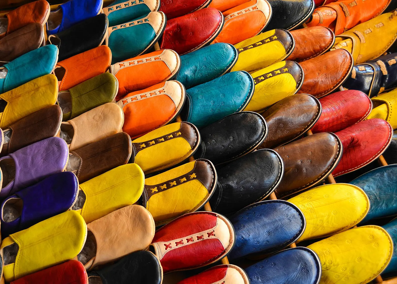 Rows of colourful leather babouche slippers in a Marrakech souk