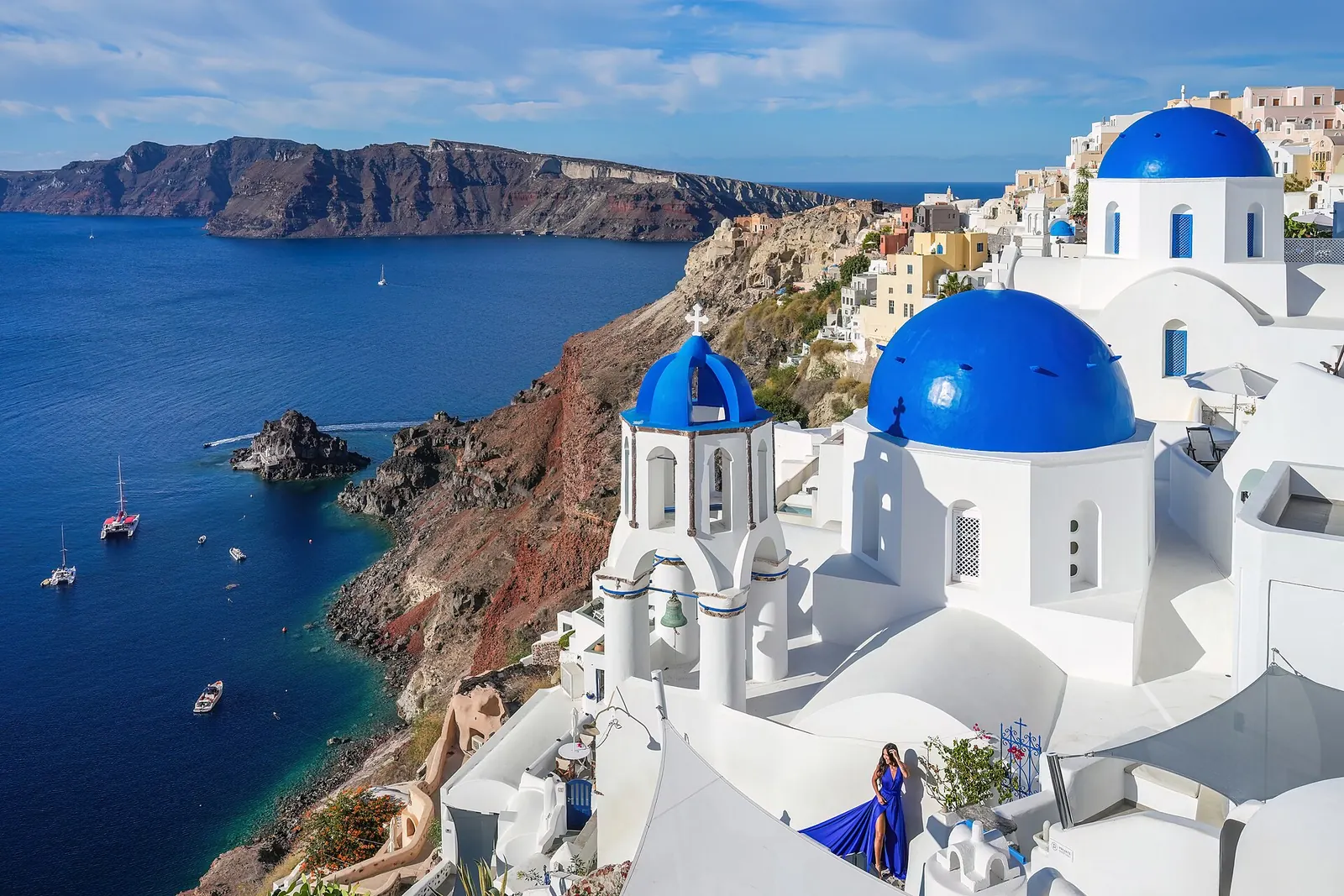 Whitewashed churches with blue domes above the sea in Oia, Santorini