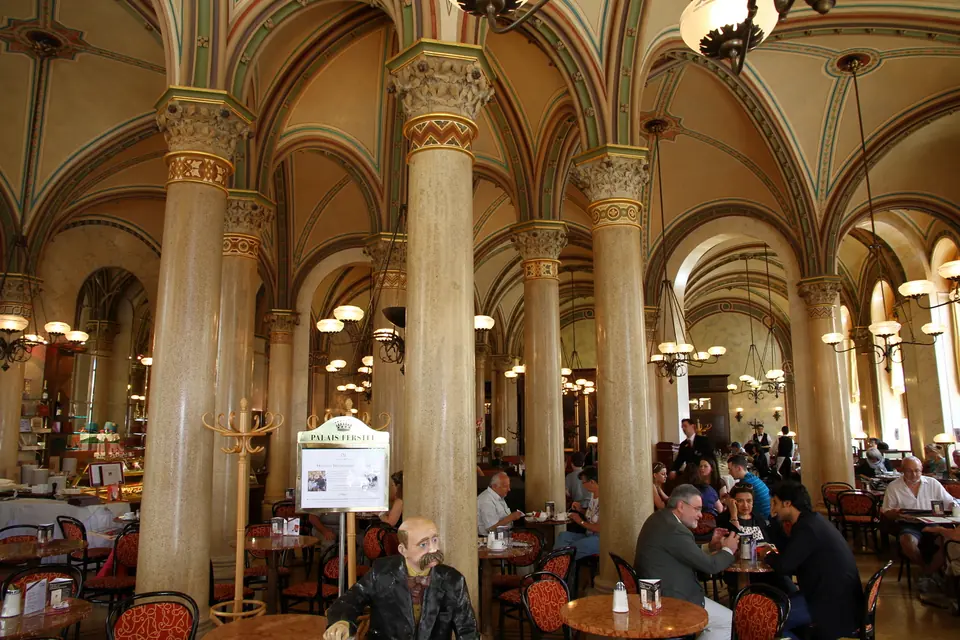 Cafe Central in Vienna interior near entrance with statue of Peter Altenberg